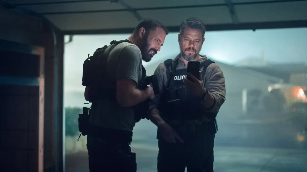 ben-affleck-and-matt-damon-in-tactical-gear-staring-at-a-phone-screen-in-the-rip The Rip